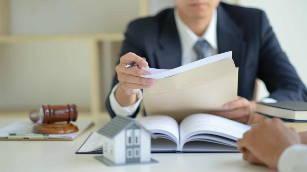 Avvocato analizza documenti legali durante consulenza con cliente